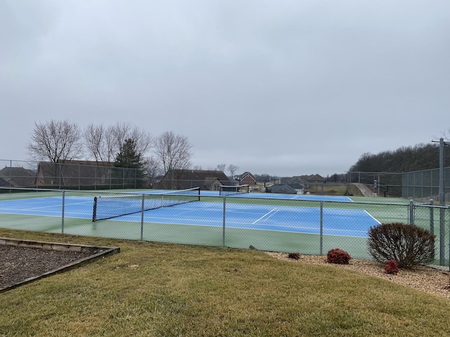 view of sport court featuring a lawn and fence