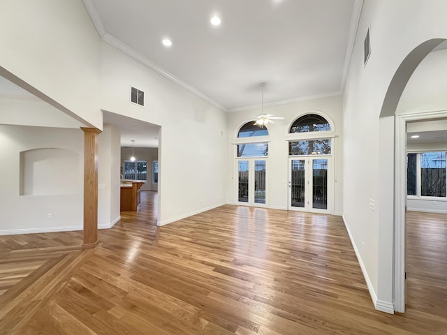 interior space with a high ceiling, crown molding, and wood-type flooring