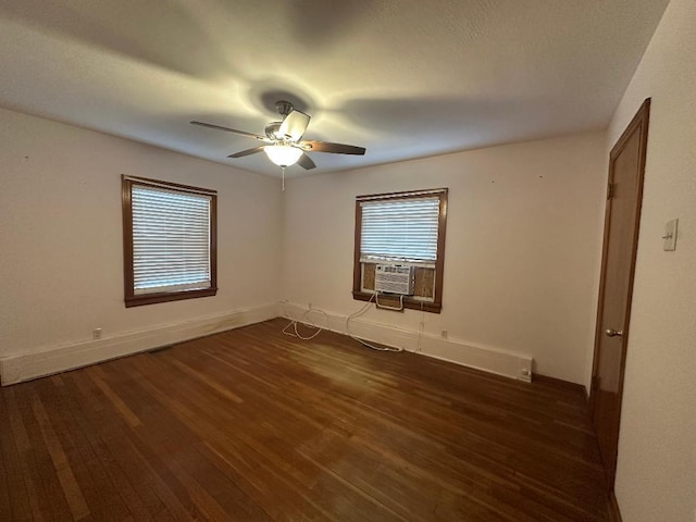 empty room featuring dark hardwood / wood-style floors, cooling unit, and ceiling fan