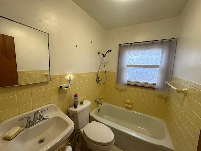 full bathroom with shower / tub combination, sink, tile walls, and toilet