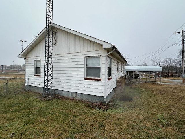 view of property exterior with a yard and a carport