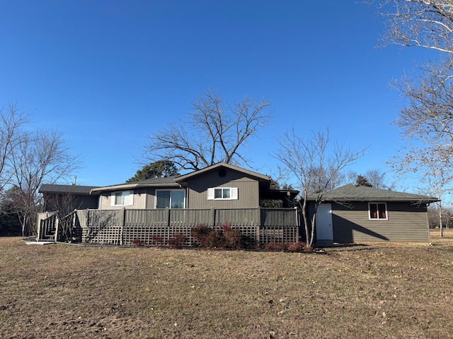 back of property featuring a yard and a deck