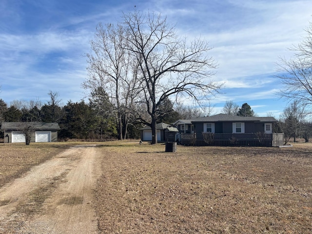 view of front of property with a garage and an outdoor structure