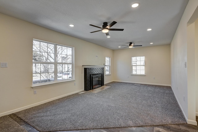 unfurnished living room with a fireplace and carpet