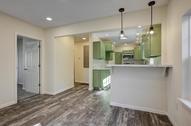 kitchen with dark hardwood / wood-style flooring, kitchen peninsula, and green cabinets