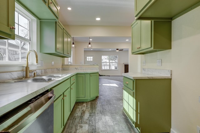 kitchen featuring sink, green cabinetry, hanging light fixtures, dark hardwood / wood-style floors, and dishwasher