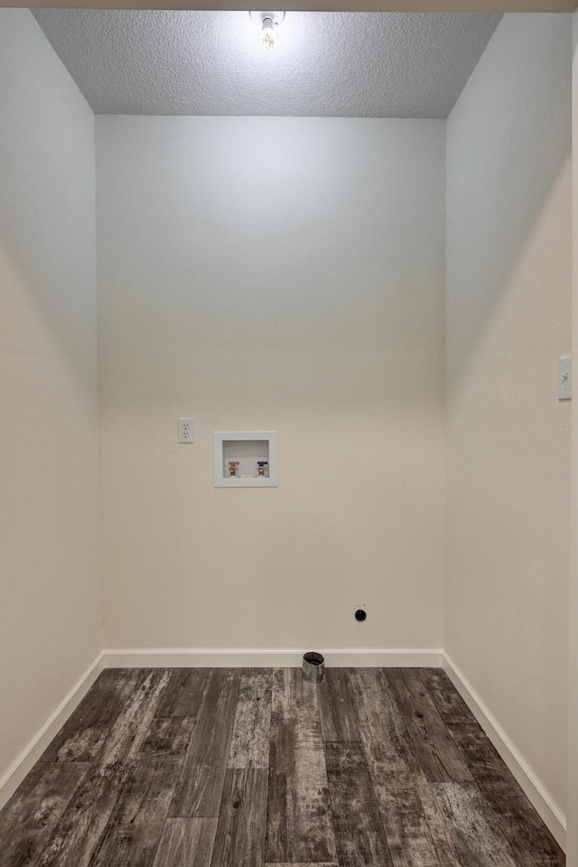 laundry room featuring hookup for a washing machine, dark wood-type flooring, and a textured ceiling