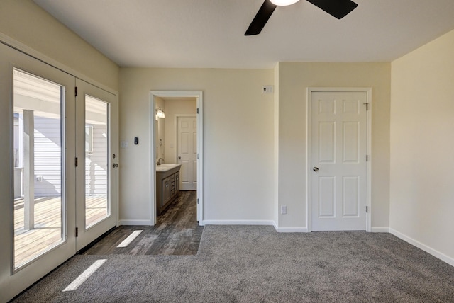 unfurnished bedroom featuring sink, ceiling fan, connected bathroom, dark carpet, and access to outside