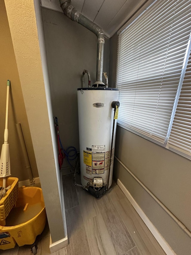 utility room featuring gas water heater