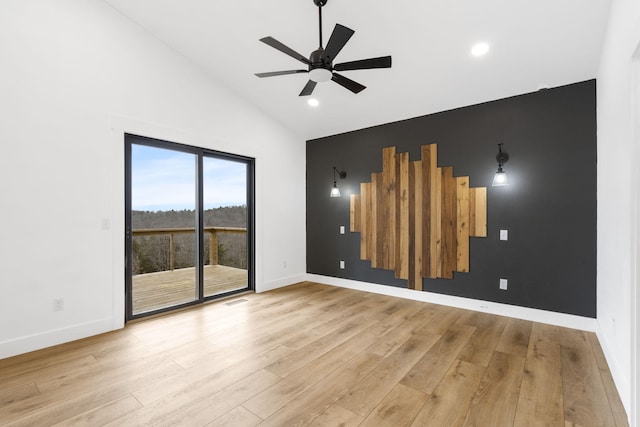 spare room with ceiling fan, high vaulted ceiling, and light hardwood / wood-style flooring