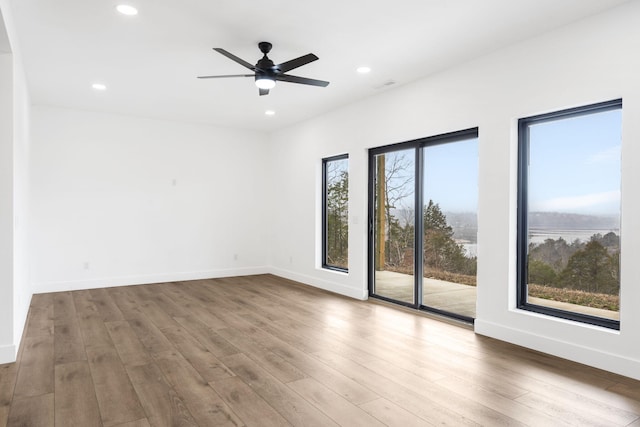 unfurnished room featuring hardwood / wood-style floors and ceiling fan