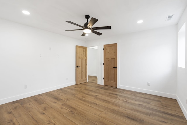 spare room featuring hardwood / wood-style floors and ceiling fan