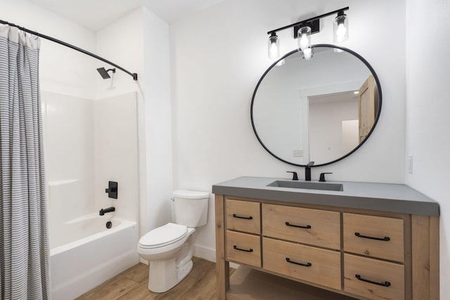 full bathroom featuring vanity, toilet, hardwood / wood-style floors, and shower / bath combo with shower curtain