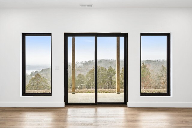 doorway with hardwood / wood-style floors