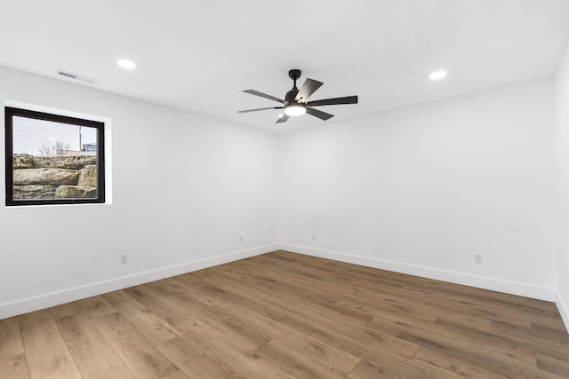 empty room with ceiling fan and wood-type flooring