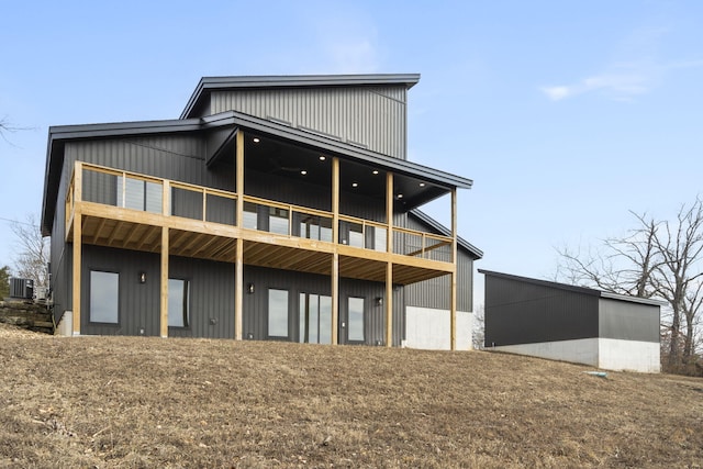 rear view of property featuring a yard and central AC