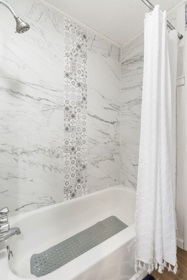 bathroom featuring shower / bathtub combination with curtain and hardwood / wood-style flooring