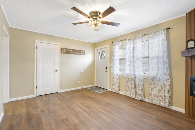 entrance foyer with wood-type flooring, a textured ceiling, and ceiling fan