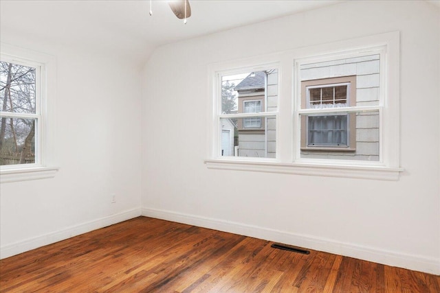 unfurnished room with lofted ceiling, hardwood / wood-style floors, and ceiling fan