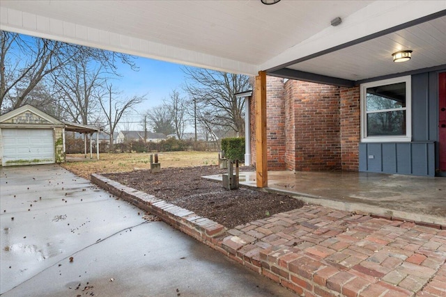 view of patio with a garage and an outdoor structure