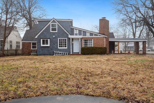 view of front of property with central AC unit and a front lawn