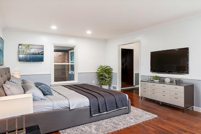 bedroom with crown molding and dark hardwood / wood-style floors