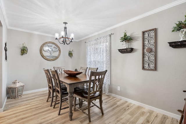 dining area featuring crown molding, a chandelier, and light hardwood / wood-style flooring