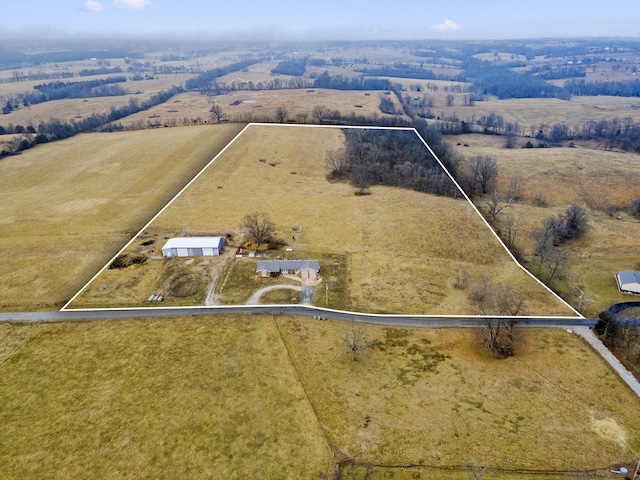 birds eye view of property with a rural view