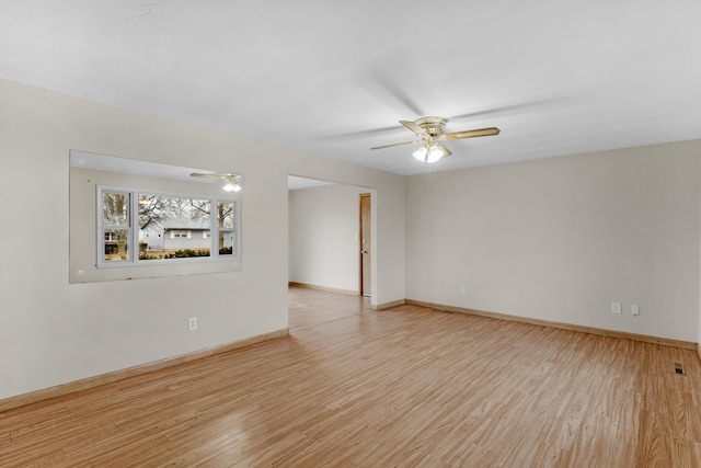 empty room with light hardwood / wood-style flooring and ceiling fan