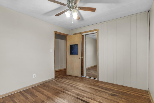 unfurnished bedroom with hardwood / wood-style flooring, ceiling fan, and a closet