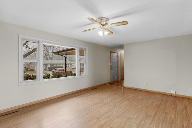 empty room featuring ceiling fan and light hardwood / wood-style flooring