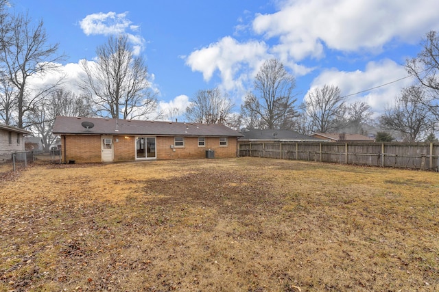 rear view of house featuring a yard