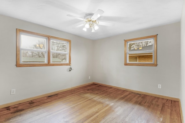 unfurnished room with ceiling fan and light wood-type flooring