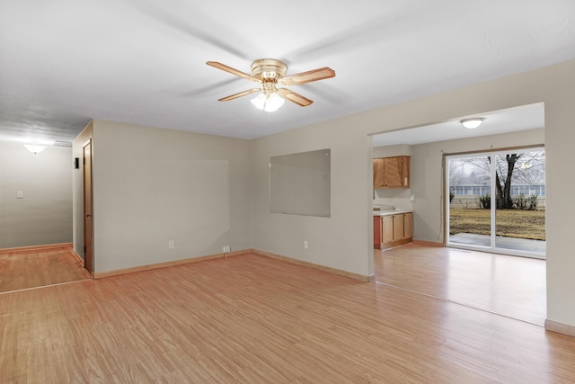 unfurnished living room with ceiling fan and light hardwood / wood-style floors