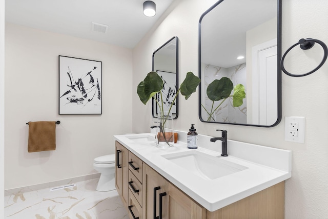 bathroom featuring vanity and toilet