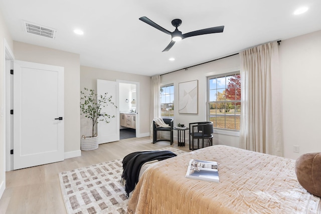 bedroom with ceiling fan, light hardwood / wood-style floors, and ensuite bath