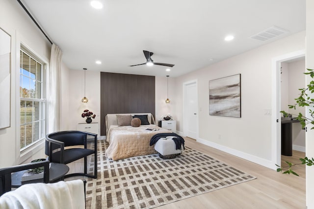 bedroom with ceiling fan and light wood-type flooring