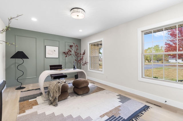 office space with light hardwood / wood-style flooring and a wealth of natural light