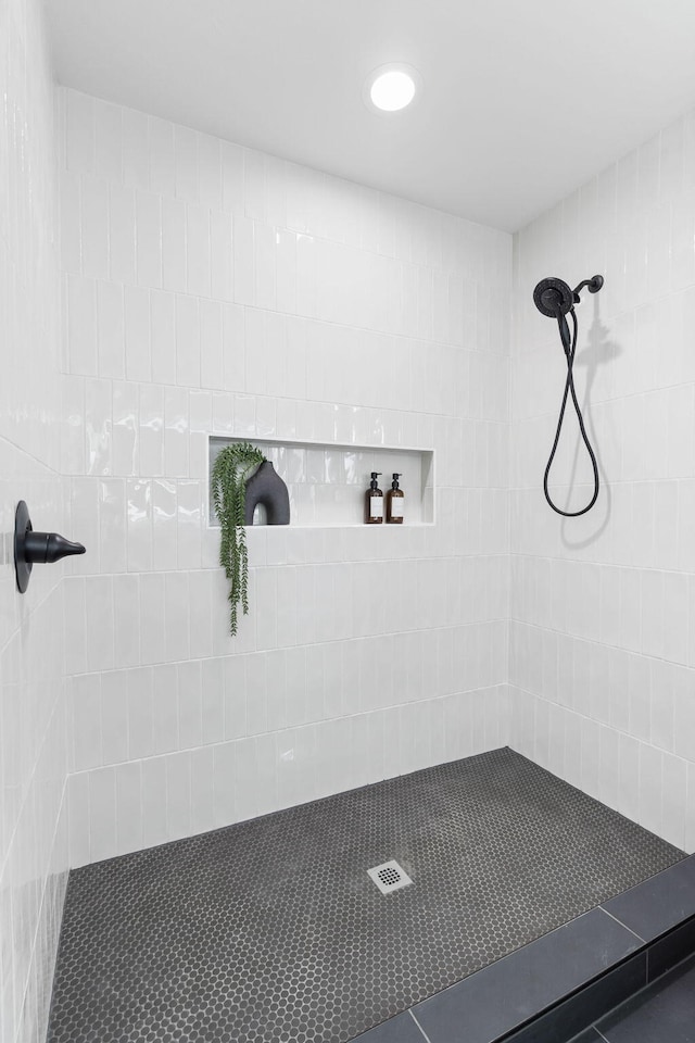 bathroom with tiled shower