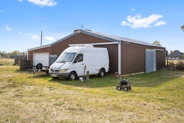 view of outbuilding with a yard and a garage