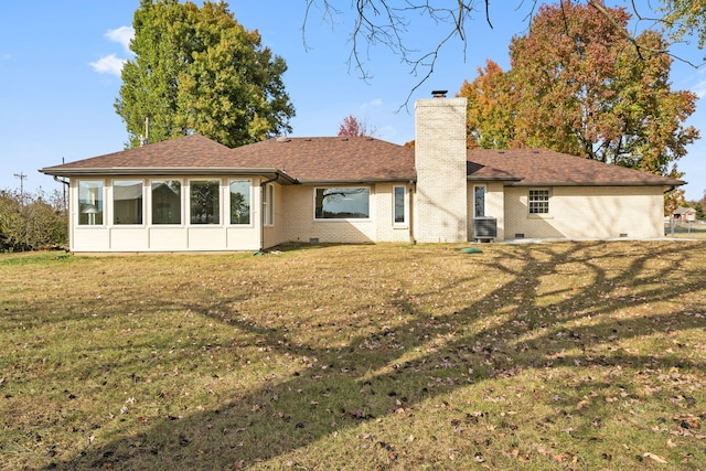 rear view of property with cooling unit and a lawn