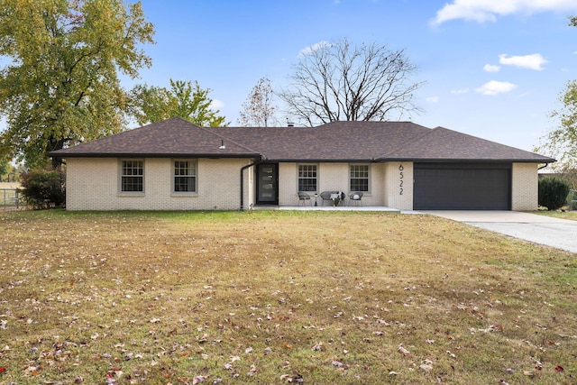 ranch-style house featuring a garage and a front yard