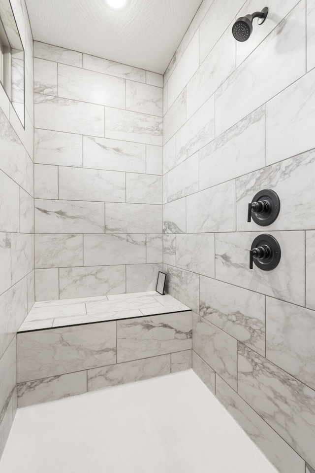 bathroom with a tile shower