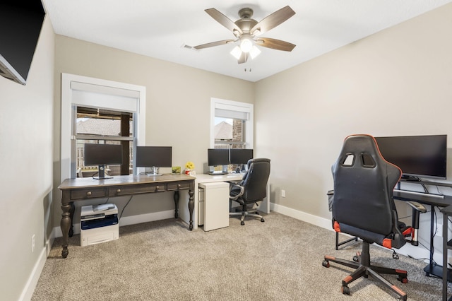 carpeted home office with ceiling fan