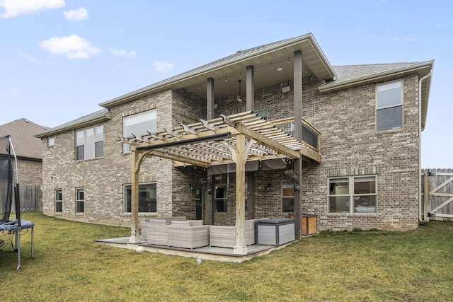 rear view of property featuring a patio area, a trampoline, a yard, outdoor lounge area, and a pergola