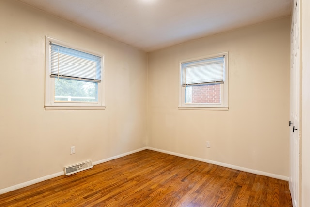 unfurnished room with hardwood / wood-style floors