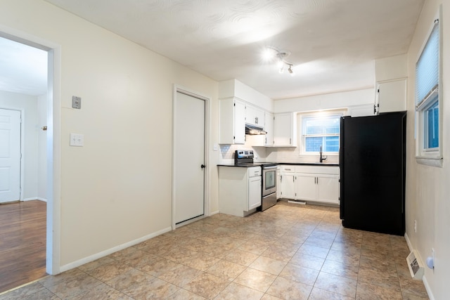 kitchen with white cabinetry, black refrigerator, sink, and electric range