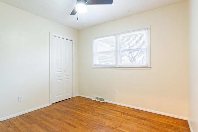 empty room featuring ceiling fan and light wood-type flooring