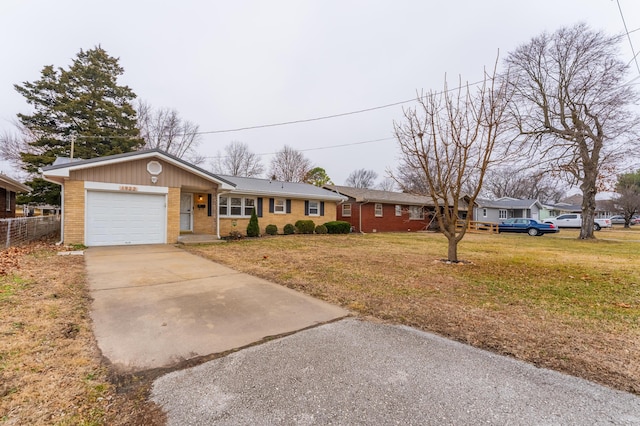 ranch-style house with a garage and a front yard