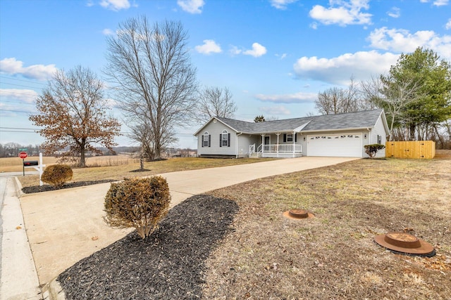 ranch-style home with a garage and covered porch